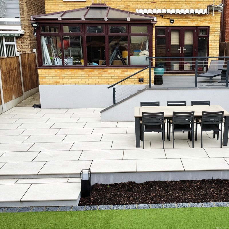 Load image into Gallery viewer, Outdoor patio area with a table and chairs in front of a brick building.
